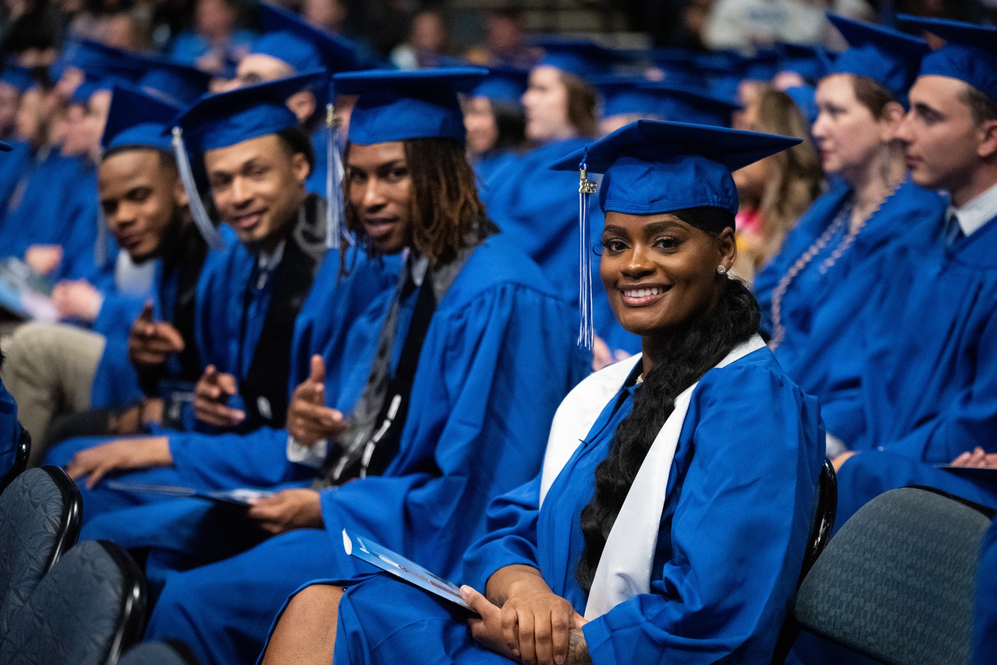 students smiling at commencement